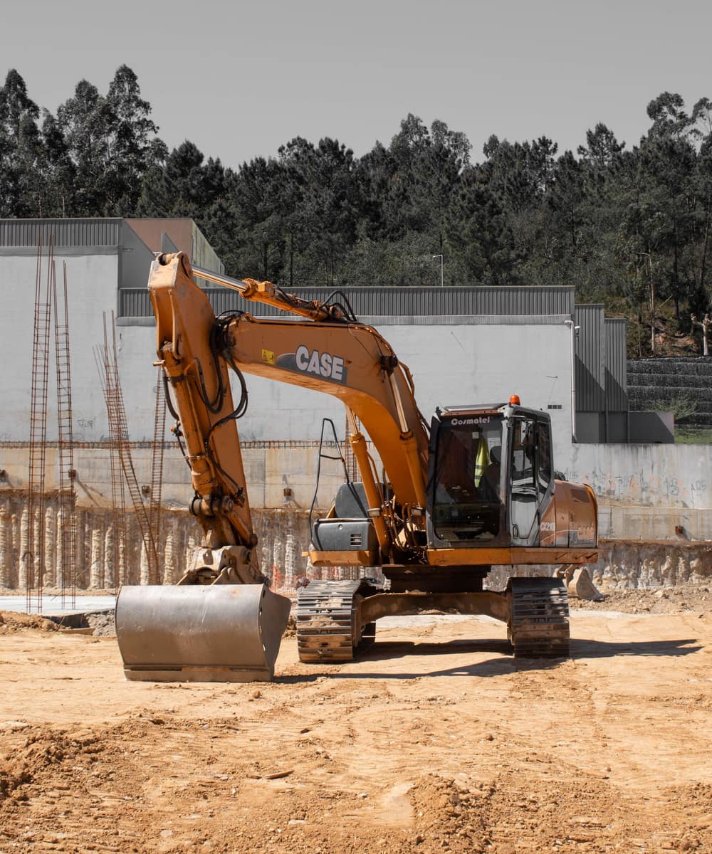 A tracked excavator working a cleared site